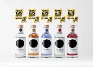 Full Awildian Gin range with award-winning bottles displayed in a row.