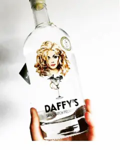 Close-up of Daffy's Gin bottle being held up against a white background