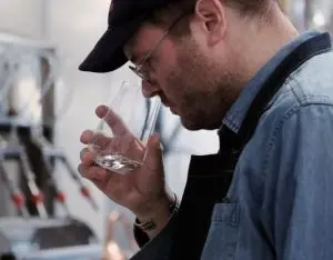 Himbrimi Distiller from Icelandic Spirits evaluating gin aroma during production