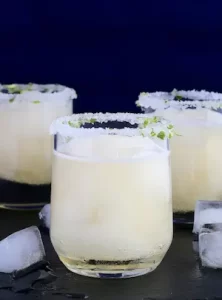 TAHU Margarita cocktail served over ice with salted rim and lime zest