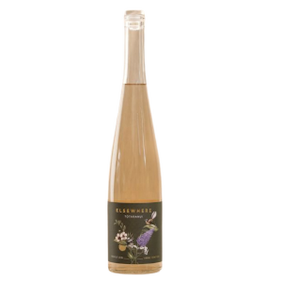 Elsewhere Totaranui Gin bottle with dark floral label and golden hue