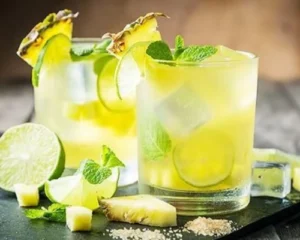 Zanzibar Spiced Gin & Tonic cocktail with pineapple, lime and fresh mint — tropical craft gin serve inspired by the Spice Island