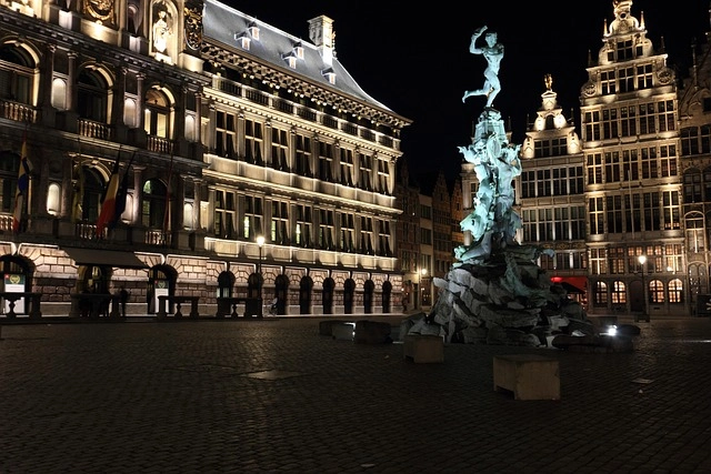 Illuminated buildings and Brabo Fountain in Antwerp at night