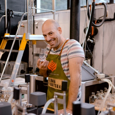 Vlaho Carević, founder of Habitat Distillery in Croatia, holding a tasting glass in the distillery