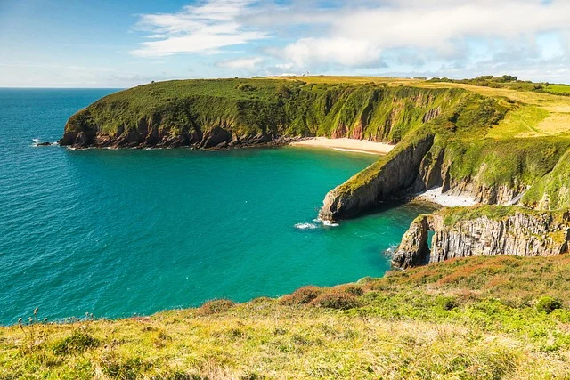 Scenic Welsh coastline with cliffs, turquoise water and a secluded beach