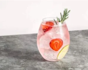 Pink Gin Spritz cocktail with strawberries, lemon and rosemary