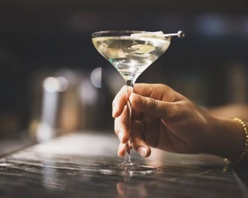Midnight Blossom, a Martini-style gin cocktail served in a chilled glass at the bar