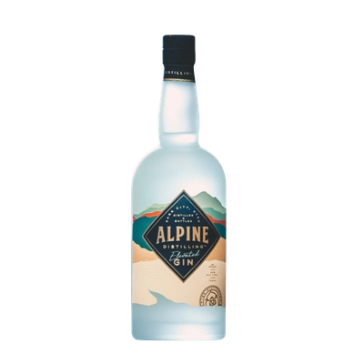 Bottle of Alpine Elevated Gin with a frosted light blue glass and a diamond-shaped label featuring a mountain landscape